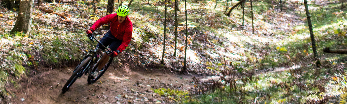 Owner of Compass Heath & Wellness, Josh Watson riding his bike in the woods